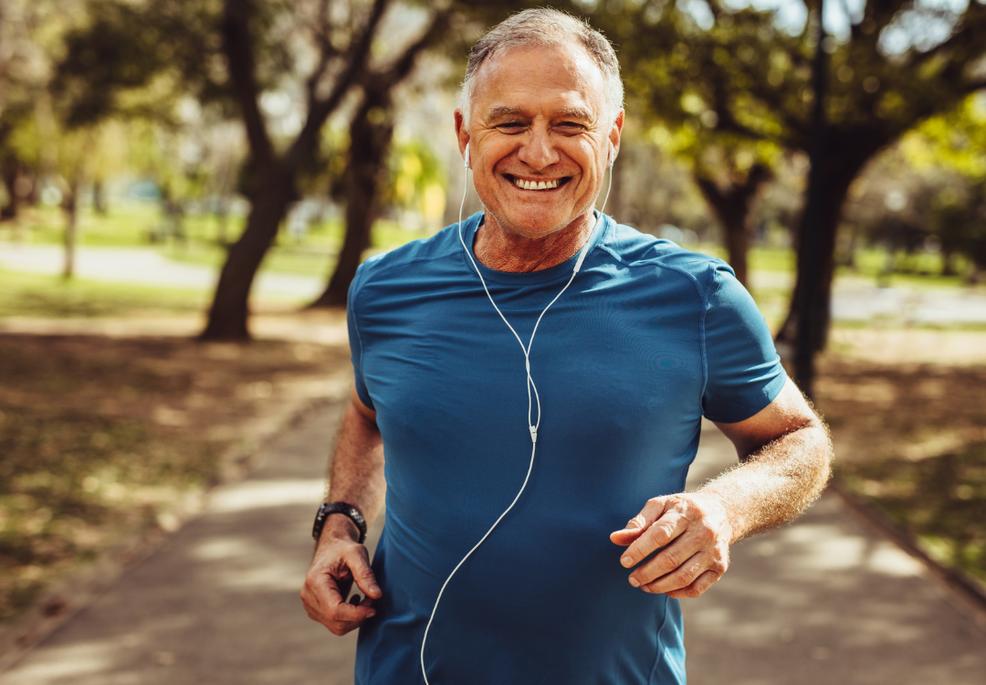 older man smiling and going for a run