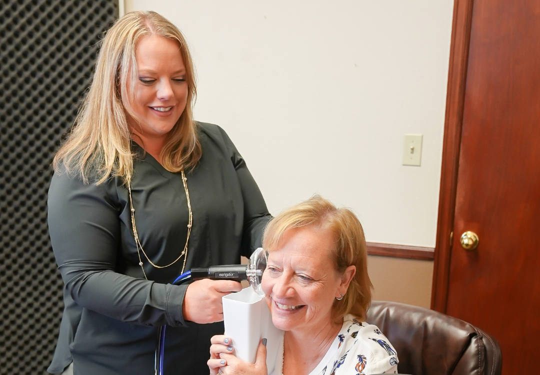 woman cleaning another person's ears